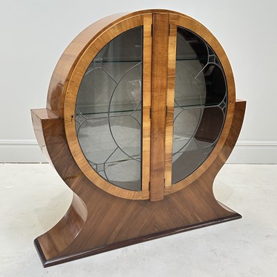 Lot 1018 - An Art Deco walnut display cabinet of circular...