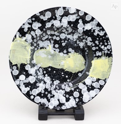 Lot 732 - A large tin glazed earthenware dish splattered...