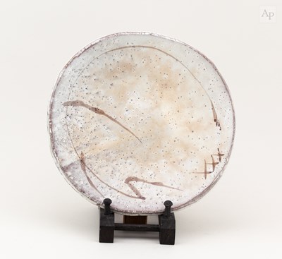 Lot 737 - A stoneware plate covered in pitted cream...