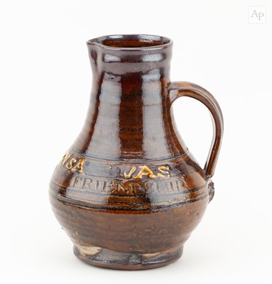 Lot 77 - Leach Pottery; a slipware calligraphic jug...
