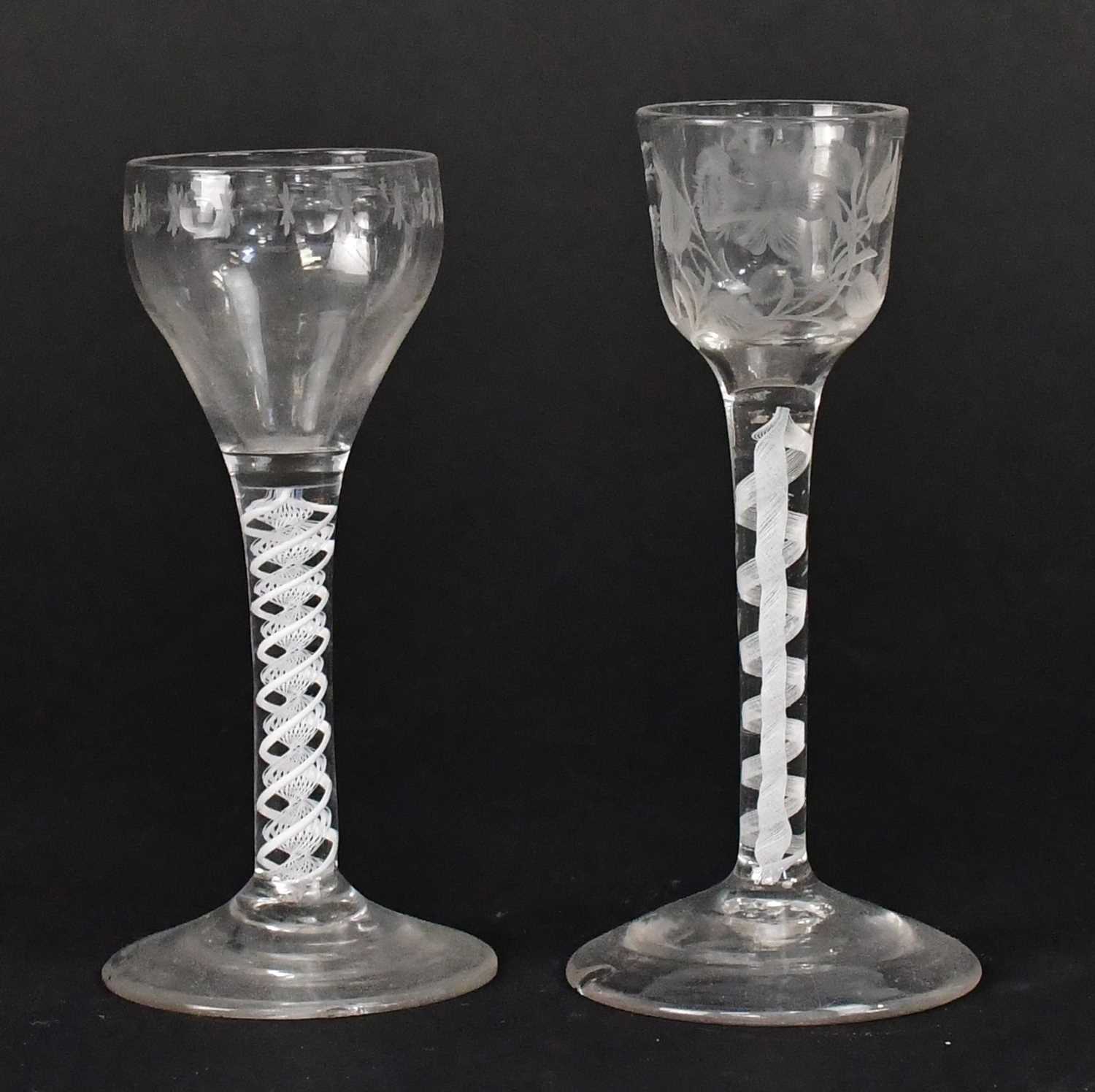 Lot 565 - Two Georgian air twist stem wine glasses, one...