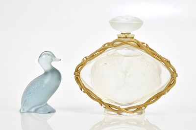 Lot 266 - LALIQUE FRANCE; a frosted glass perfume bottle,...