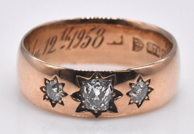 Lot 488 - A 9ct gold three stone diamond gentleman's...