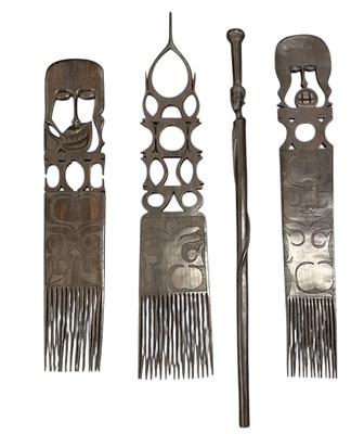 Lot 1060 - Three large African carved wooden combs,...