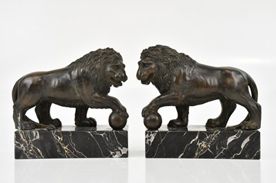 Lot 1497 - A pair of bronze 'Medici' lions on marble...