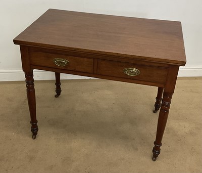 Lot 785 - A mahogany two drawer side table, raised on...