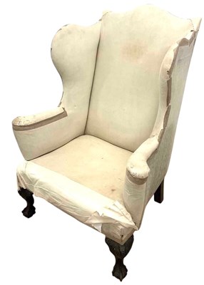 Lot 689 - A 19th century wingback armchair of generous...