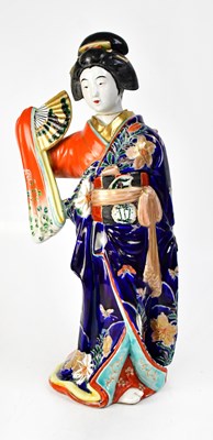 Lot 380 - A ceramic figure of a Japanese lady in...