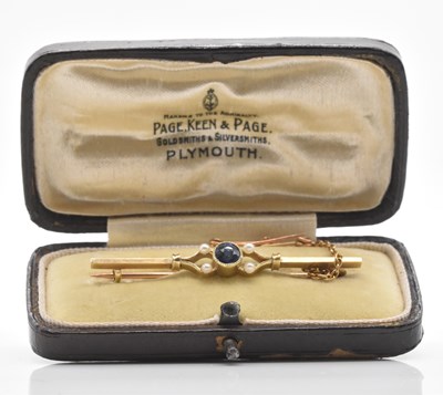 Lot 554 - A 15ct yellow gold pearl set bar brooch in...