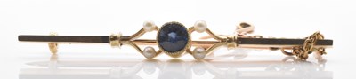 Lot 554 - A 15ct yellow gold pearl set bar brooch in...