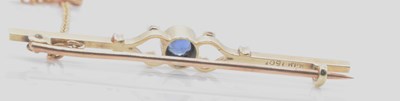Lot 554 - A 15ct yellow gold pearl set bar brooch in...