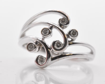 Lot 525 - A 9ct white gold six stone diamond set ring of...