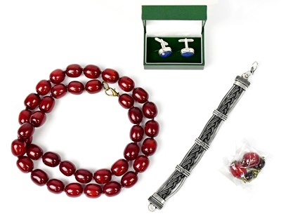 Lot 1510 - A cherry amber style resin necklace with...