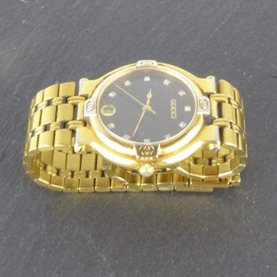 Lot 1397 - GUCCI; a ladies' gold plated wristwatch,...