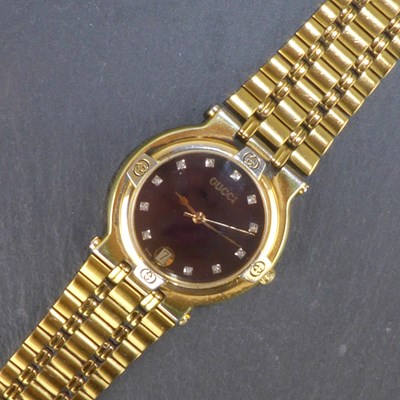 Lot 1397 - GUCCI; a ladies' gold plated wristwatch,...