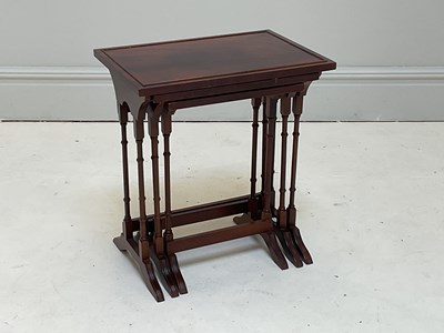 Lot 1133 - A reproduction nest of three mahogany effect...