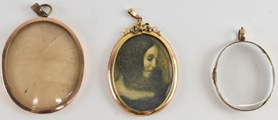Lot 1203 - Three yellow metal mounted locket pendants,...