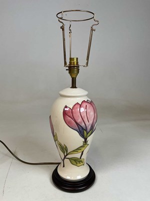 Lot 219 - MOORCROFT; a large table lamp decorated in the...