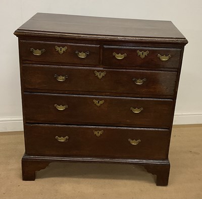 Lot 712 - A Georgian oak chest of two short over three...