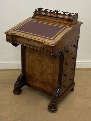 Lot 735 - A walnut Davenport, the top with dark red...