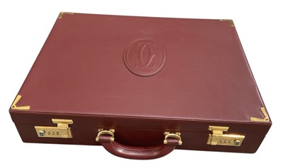 Lot 451 - MUST DE CARTIER; a gentleman's red leather...