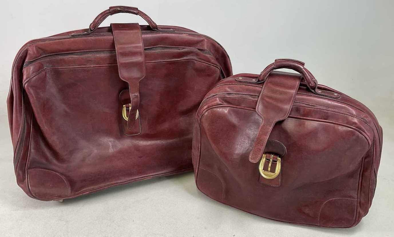 Lot 92 - Two vintage burgundy leather suitcases, both...