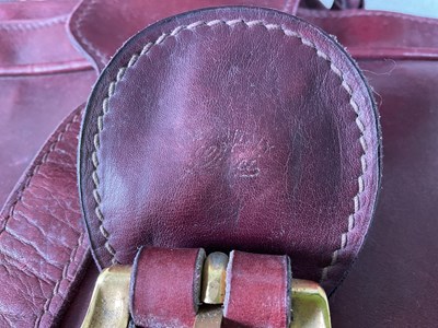Lot 92 - Two vintage burgundy leather suitcases, both...