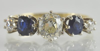 Lot 1209 - A diamond and sapphire set gold ring, the...