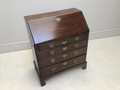Lot 1068 - A George III oak bureau, with fall front...