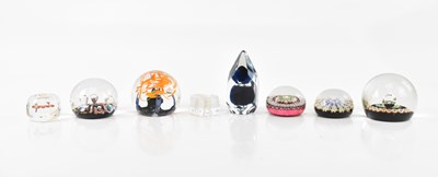 Lot 2388 - A collection of seven glass paperweights, to...