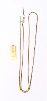 Lot 1428 - A Degussa 999.9 fine gold 10g ingot pendant,...