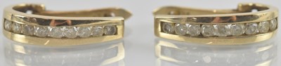 Lot 1313 - A pair of 9ct gold hoop shaped earrings, with...