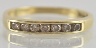 Lot 1251 - A 9ct gold ring, with seven channel set small...