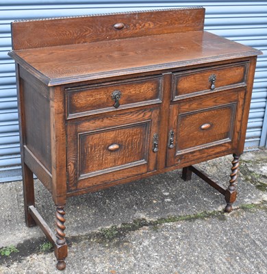 Lot 39 - An oak sideboard with beaded decoration on...