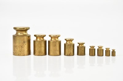 Lot 1347 - A set of nine graduated brass weights.