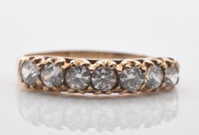 Lot 548 - A 9ct yellow gold seven stone dress ring, size...