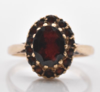 Lot 549 - A 9ct yellow gold garnet set cluster ring,...