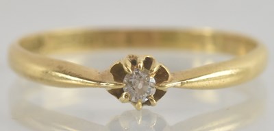 Lot 1247 - An 18ct gold diamond solitaire ring, size S,...