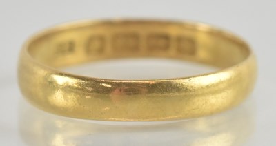 Lot 1218 - A 22ct gold thin band ring, size S, approx 3.2g.