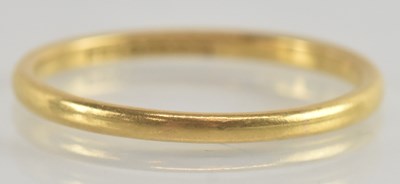 Lot 1228 - A 22ct gold thin band ring, size S, approx 2.5g.