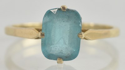 Lot 1261 - A 9ct gold dress ring, with claw set blue cut...