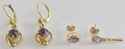 Lot 1309 - A pair of 9ct gold earrings with amethyst set...