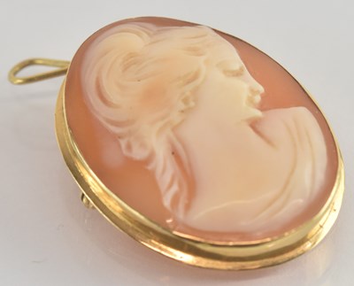 Lot 1330 - A gold cameo brooch, the central carved shell...