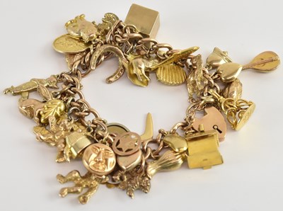 Lot 1332 - A 9ct gold charm bracelet, with approximately...