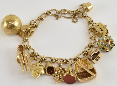 Lot 1334 - A 9ct gold charm bracelet, with approximately...