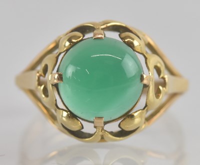 Lot 1245 - A 14ct gold dress ring, with claw set green...