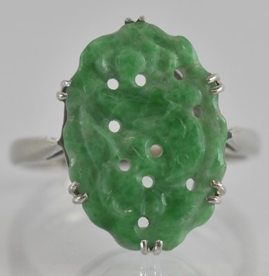 Lot 1230 - An 18ct white gold ring, with claw set carved...