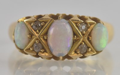 Lot 1214 - An 18ct gold opal and diamond set ring, the...