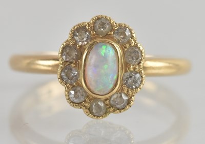 Lot 1215 - An 18ct gold opal and diamond floral cluster...