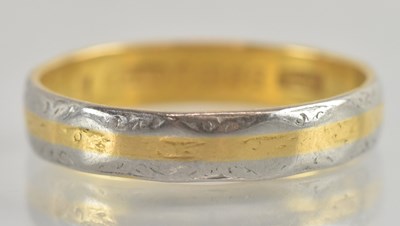 Lot 1212 - A 22ct gold and platinum band ring, the...